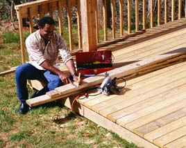 Measuring boards to build the perfect wood deck.