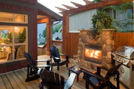 Fireplace outside on this deck besides stainless barbecue
