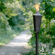 gas tiki torch on a garden path